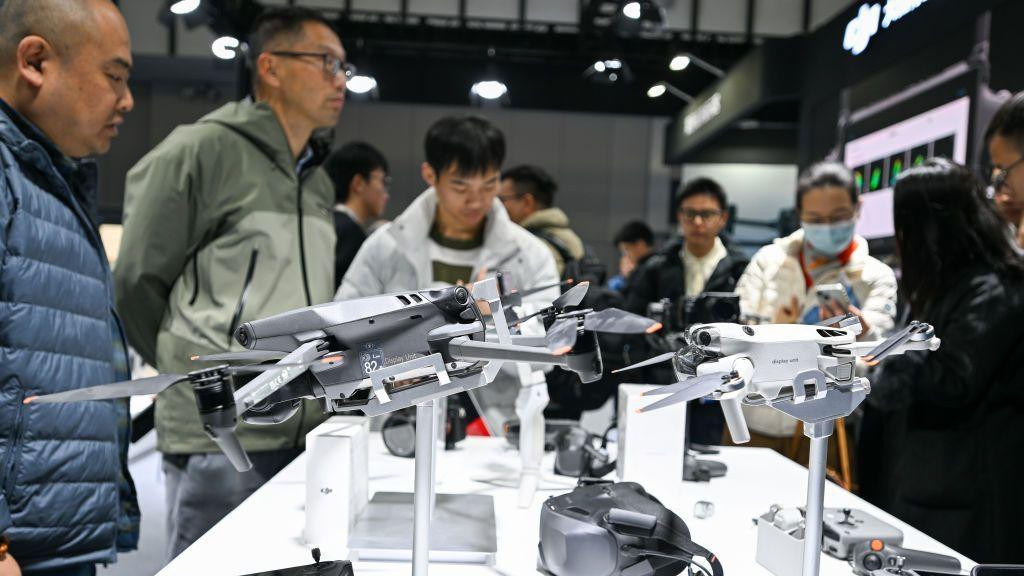 Visitors observe DJI drones at the World Intelligent Manufacturing Expo 2024 in Nanjing
