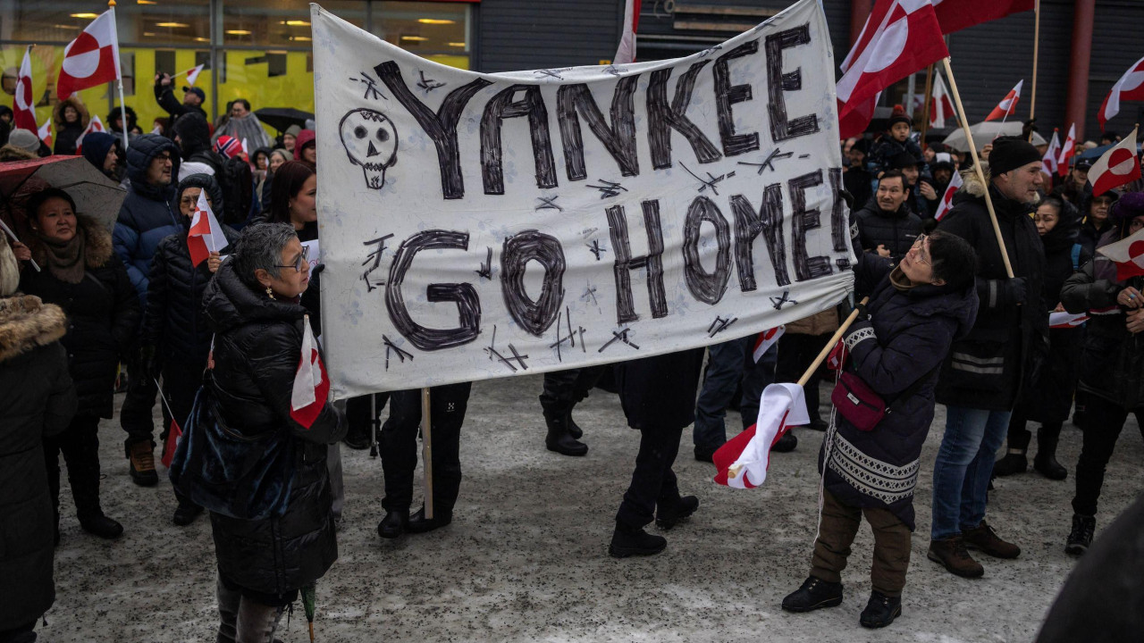 dve žene drže transparent 'Jenki (Amerikanci), idite kući' na demonstracijama u Nuku, glavnom gradu Grenlanda